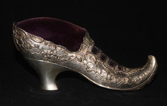 A late 19th/early 20th century German Hanau silver novelty slipper pin cushion, 16cm.